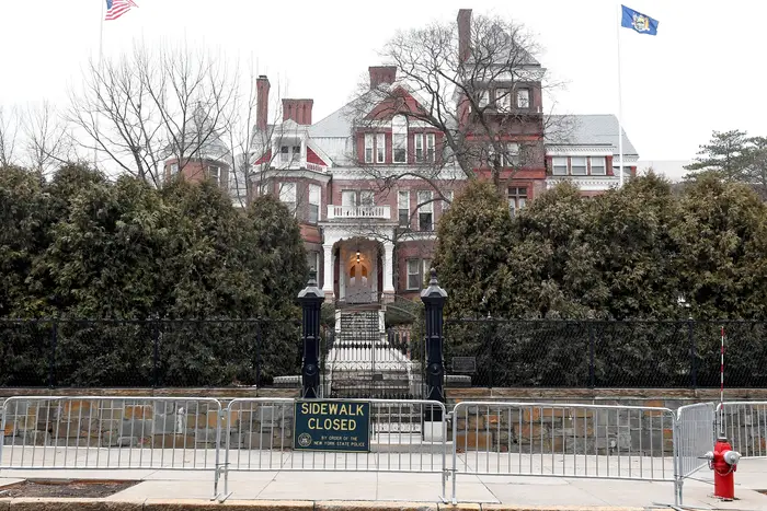 The exterior of the Governor's mansion, with a police barricade on the sidewalk